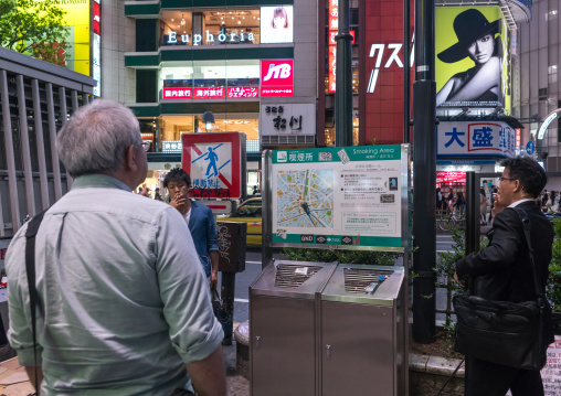 Men in a outdoors public smoking area in shibuya, Kanto region, Tokyo, Japan