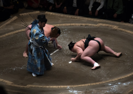 Two sumo wrestlers fighting at the ryogoku kokugikan arena, Kanto region, Tokyo, Japan