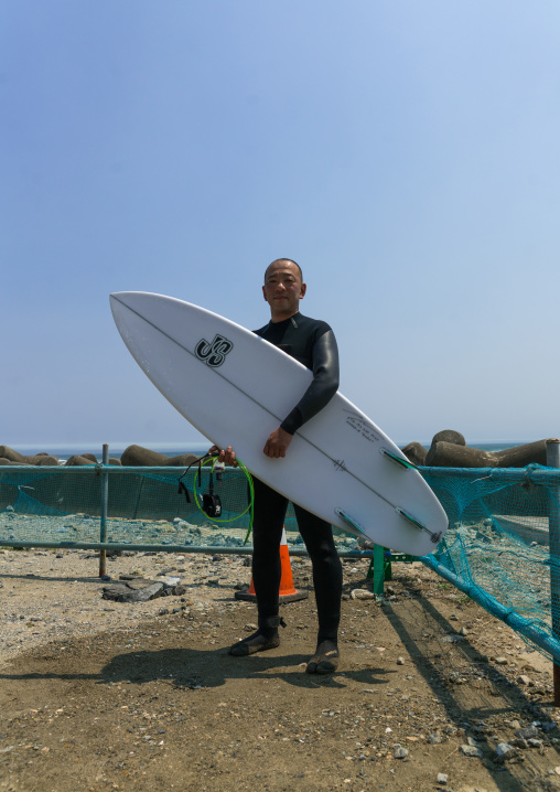 Japanese surfer in the contaminated area after the daiichi nuclear power plant irradiation, Fukushima prefecture, Tairatoyoma beach, Japan