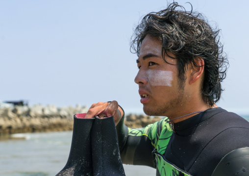 Japanese surfer in the contaminated area after the daiichi nuclear power plant irradiation, Fukushima prefecture, Tairatoyoma beach, Japan