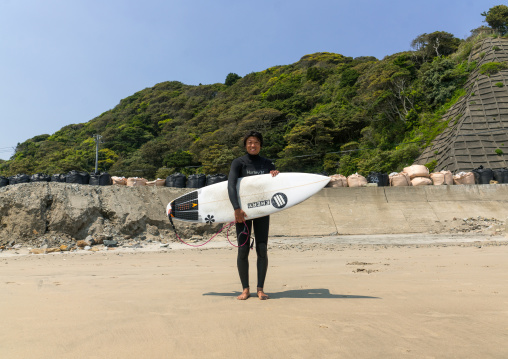 Japanese surfer in the contaminated area after the daiichi nuclear power plant irradiation, Fukushima prefecture, Tairatoyoma beach, Japan