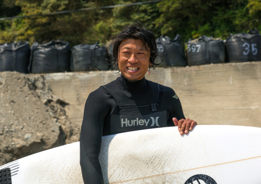 Japanese surfer in the contaminated area after the daiichi nuclear power plant irradiation, Fukushima prefecture, Tairatoyoma beach, Japan