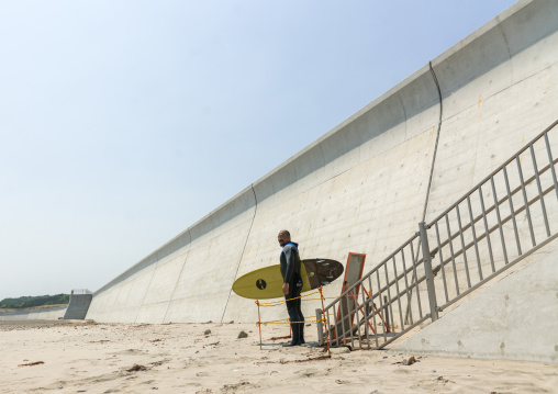 Japanese surfer in the contaminated area after the daiichi nuclear power plant irradiation, Fukushima prefecture, Tairatoyoma beach, Japan