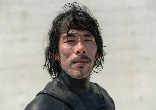 Japanese surfer in the contaminated area after the daiichi nuclear power plant irradiation, Fukushima prefecture, Tairatoyoma beach, Japan