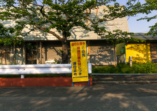 A sign warns people in the difficult-to-return zone after the daiichi nuclear power plant irradiation, Fukushima prefecture, Tomioka, Japan