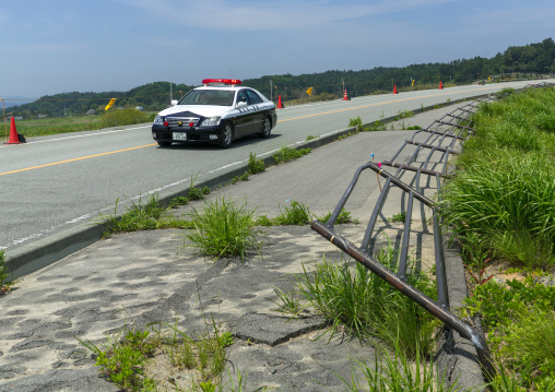 Police car patroling in the highly contaminated area after the daiichi nuclear power plant irradiation, Fukushima prefecture, Futaba, Japan