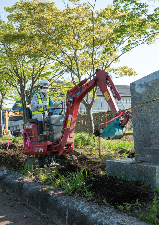 Decontamination work no entry sign in front of workers who remove top soil contaminated by nuclear radiations after the daiichi nuclear power plant explosion, Fukushima prefecture, Iitate, Ja