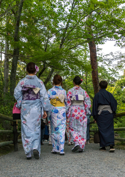 Chinese tourist women wearing geisha kimonos in a zen garden, Kansai region, Kyoto, Japan