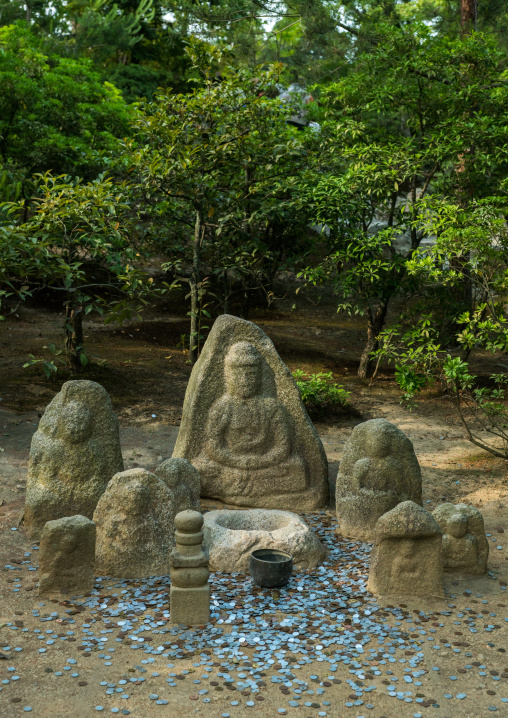 Coins donated at a shrine at the temple of the golden pavilion, Kansai region, Kyoto, Japan