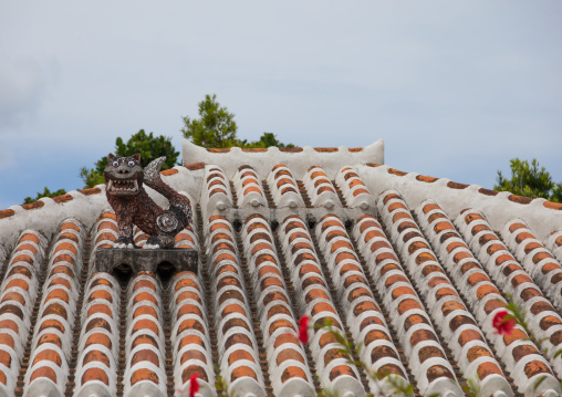 Shisa lion atop traditional tile roof to protect the house from the bad spirits, Yaeyama Islands, Taketomi island, Japan