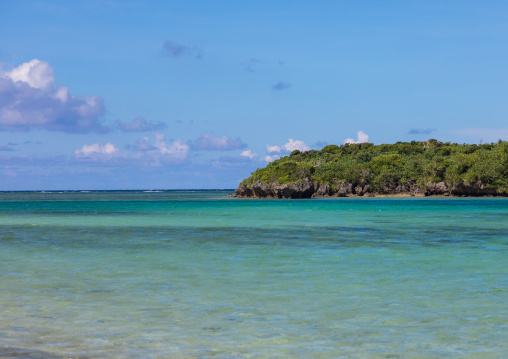 Tropical lagoon with clear blue water surrounded by lush greenery in Kabira bay, Yaeyama Islands, Ishigaki, Japan