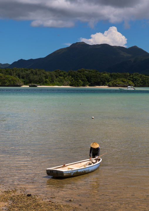 Japanese fisherman in tropical lagoon with clear blue water in Kabira bay, Yaeyama Islands, Ishigaki, Japan