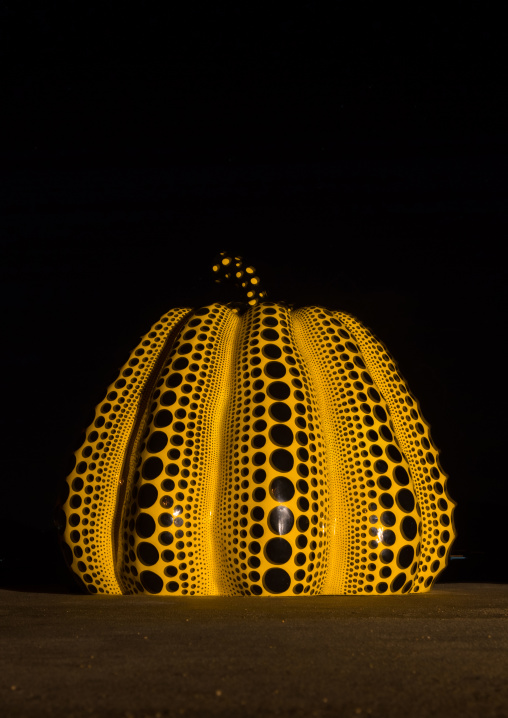 Yellow pumpkin by Yayoi Kusama on pier at night, Seto Inland Sea, Naoshima, Japan