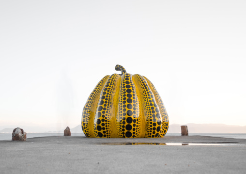 Yellow pumpkin by Yayoi Kusama on pier at sea, Seto Inland Sea, Naoshima, Japan