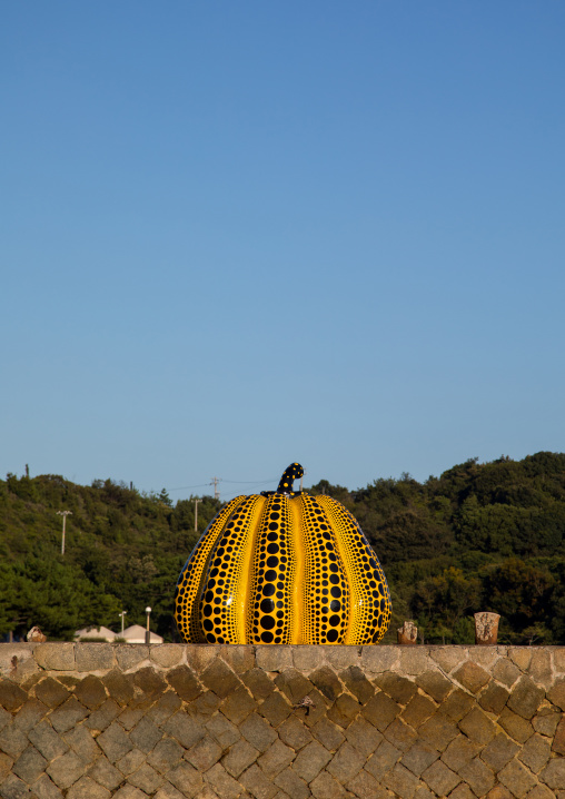 Yellow pumpkin by Yayoi Kusama on pier at sea, Seto Inland Sea, Naoshima, Japan