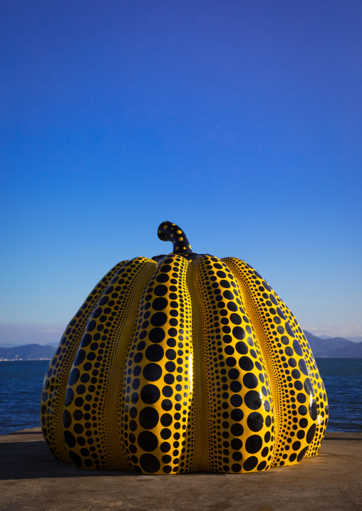 Yellow pumpkin by Yayoi Kusama on pier at sea, Seto Inland Sea, Naoshima, Japan