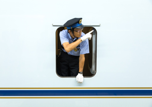 Shinkansen train controller looking thru a window, Hypgo Prefecture, Himeji, Japan