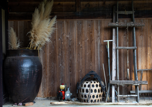 Huge jar in front of a wooden house, Kyoto Prefecture, Miyama, Japan