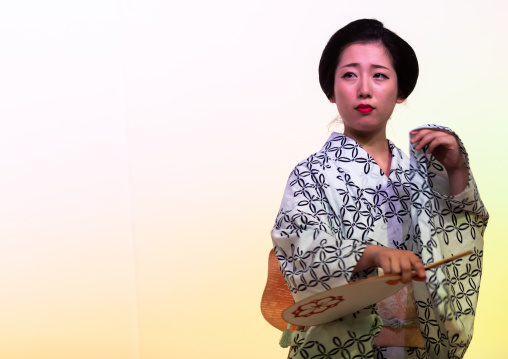 Maiko woman dancing on stage during a stage, Kansai region, Kyoto, Japan