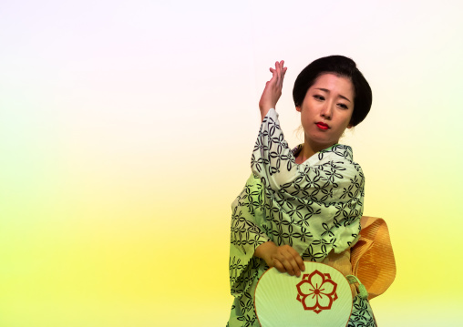 Maiko woman dancing on stage during a stage, Kansai region, Kyoto, Japan