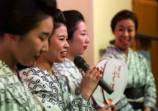 Maiko women dancing on stage during a show, Kansai region, Kyoto, Japan