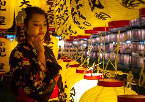 Japanese woman in yaukuta during Gokoku shrine Mitama matsuri Obon festival celebrating the return of the spirits of the deads, Kyushu region, Fukuoka, Japan