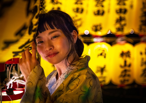 Japanese woman in yaukuta during Gokoku shrine Mitama matsuri Obon festival celebrating the return of the spirits of the deads, Kyushu region, Fukuoka, Japan