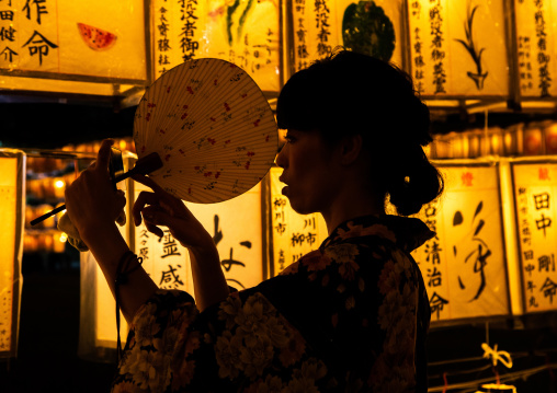 Japanese woman in yaukuta during Gokoku shrine Mitama matsuri Obon festival celebrating the return of the spirits of the deads, Kyushu region, Fukuoka, Japan