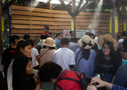 Tourists in gensen kakenagashi footbath area in Kamado jigoku, Oita Prefecture, Beppu, Japan