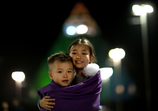 Cold Evening For Two Kids In Front Of The Peace Pyramid, Astana, Kazakhstan