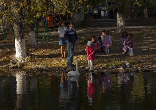 Girl Feeding A Swan In Astana Park, Kazakhstan