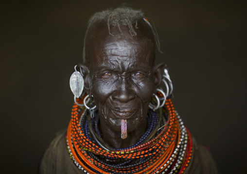 Old turkana tribe woman with huge necklaces and earrings, Turkana lake, Loiyangalani, Kenya