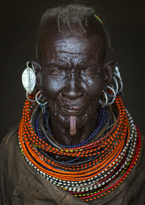 Old turkana tribe woman with huge necklaces and earrings, Turkana lake, Loiyangalani, Kenya