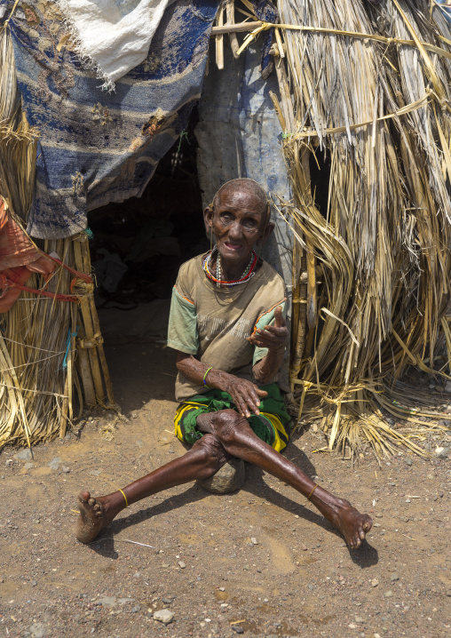 El molo handicapped tribeswoman in front of her hut, Turkana lake, Loiyangalani, Kenya