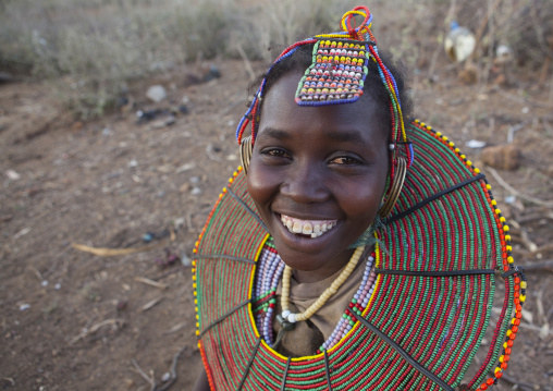 A pokot girl wears large necklaces made from the stems of sedge grass, Baringo county, Baringo, Kenya