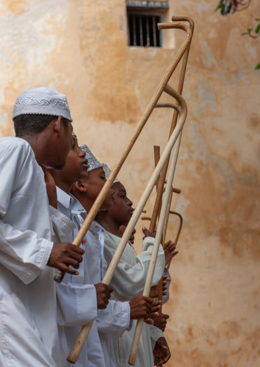 Muslim children dancing with sticks during Maulid festival, Lamu County, Lamu, Kenya