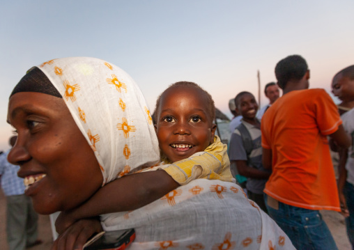 Baby on back of muslim woman during Maulid festival, Lamu County, Lamu, Kenya