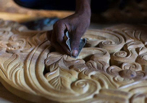 Hand polishing wooden carved door, Lamu County, Lamu, Kenya