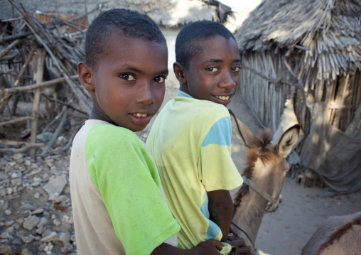 Two young boys riding a donkey, Lamu County, Lamu, Kenya