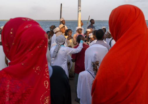 Sunni muslim men dancing during the maulidi festivities in the street, Lamu county, Lamu town, Kenya