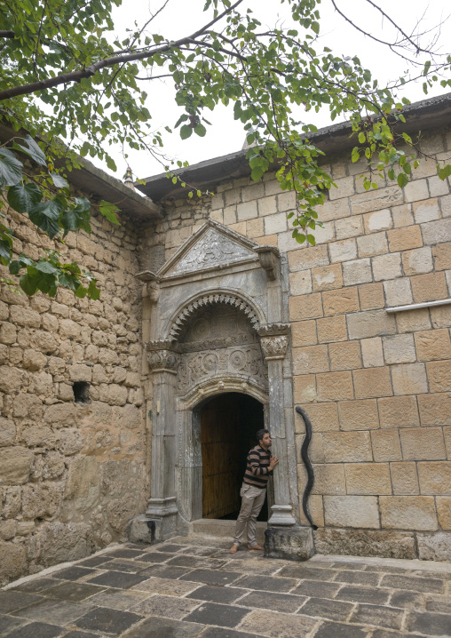 A Man Kisses A Door In The Historic Temple Of Yazidis In The Village Of Lalesh, Kurdistan, Iraq