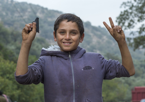 Yezedi Refugee From Sinjar Holding A Gun Toy, Lalesh Temple, Kurdistan, Iraq