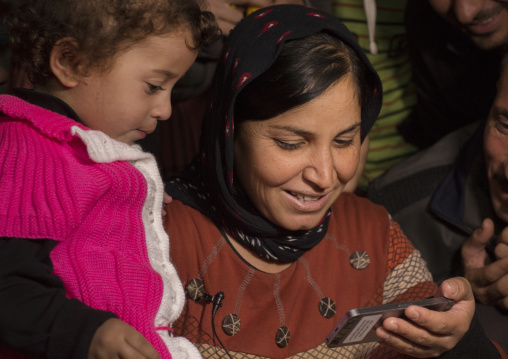 Yezedi Refugees From Sinjar Making A Conference On A Mobile Phone With Relatives, Zohar, Kurdistan, Iraq