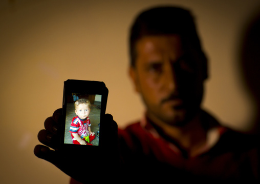 Yezedi Refugee From Sinjar Showing A Relative Killed By Daesh On His Mobile Phone, Zohar, Kurdistan, Iraq