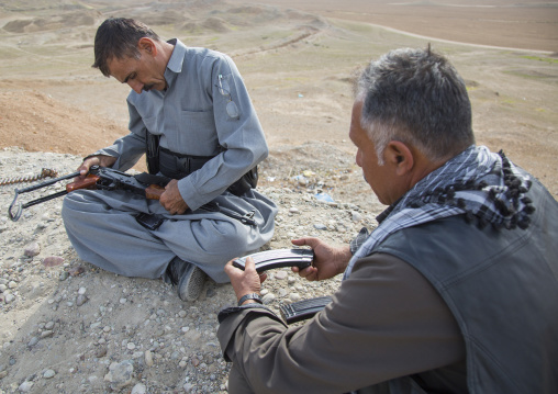 Kurdish Peshmergas Cleaning Their Kalashnikovs On The Frontline, Kirkuk, Kurdistan, Iraq