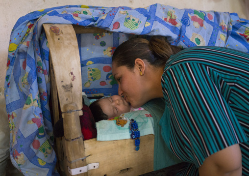 Yazidi Mother Kissing Her Baby In The Temple City Of Lalesh, Kurdistan, Iraq