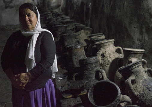 Yazidi Woman Standing In Front Of Olive Oil Jars, Temple City Of Lalesh, Kurdistan, Iraq