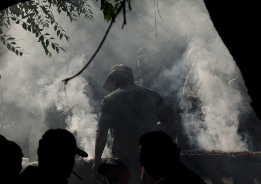 Man Grilling Meat At The Animal Market Of Kochkor, Kyrgyzstan