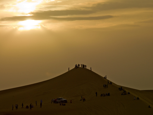 People in the desert on a dune, Tripolitania, Ghadames, Libya