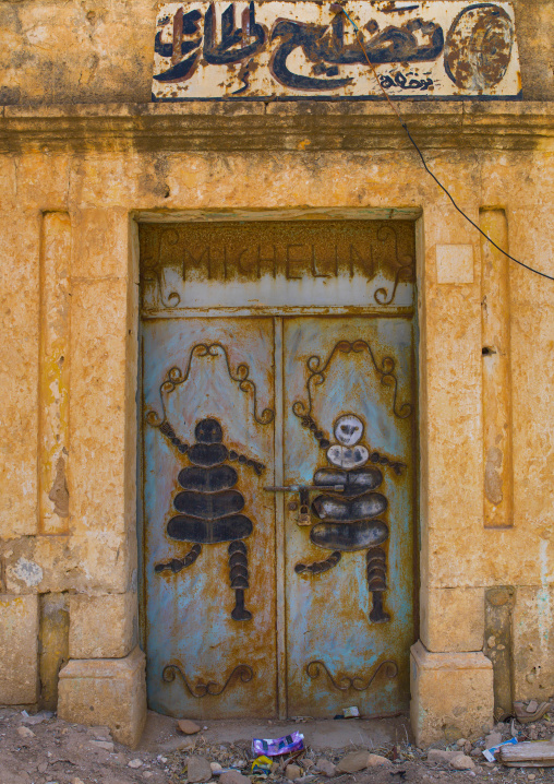 Old italian colonial shop with michelin bibendum, Cyrenaica, Ptolemais, Libya